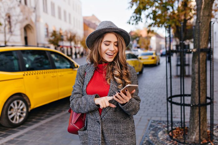 good-looking-business-woman-texting-message-while-walking-street.jpg